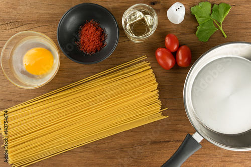 spaghetti and eggs with spice on table wood background for cooking