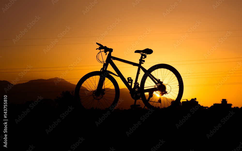 silhouette of parked bicycle on warm tone with some copy space