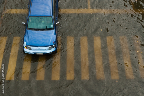 Photography Car driving on a flooded road.