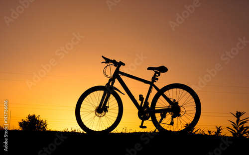 silhouette of parked bicycle on warm tone with some copy space © Rikesh Attadip