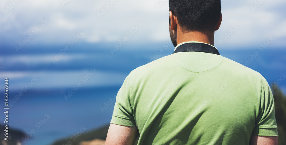 Hipster young guy with enjoying view on seascape on mountain. Tourist traveler man on background sky and blue wave landscape mockup. Hiker looking sunlight ocean in trip holiday in basque island Hipster young guy with enjoying view on seascape on mountain. Tourist traveler man on background sky and blue wave landscape mockup. Hiker looking sunlight ocean in trip holiday in basque island
