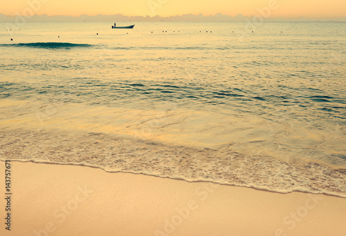 Obraz na płótnie Colorful sunset on the tropical beach with beautiful sky, clouds, boat and soft waves. Photo from Playa Del Carmen, Riviera Maya, Mexico. w salonie