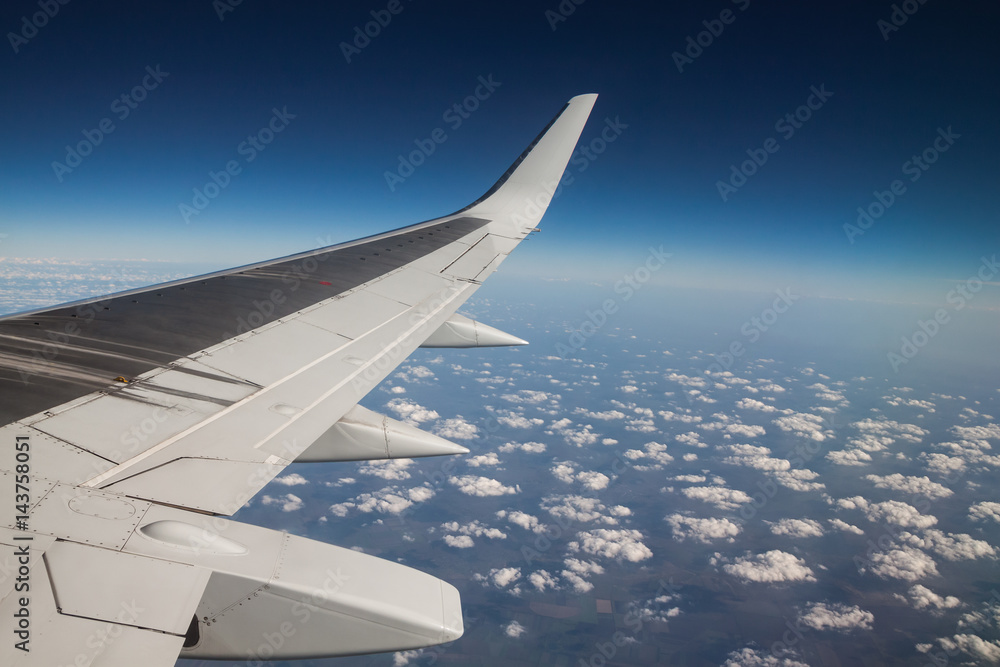 view from the airplane window to the clouds