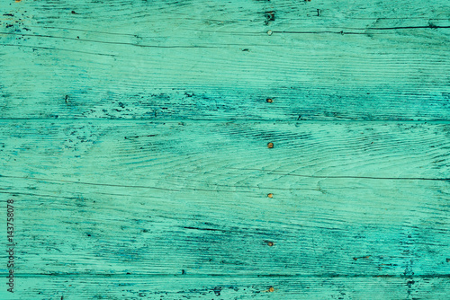 Wood plank fence in green and turquoise colors close up. Detailed background photo texture. Wooden wall abstract background.