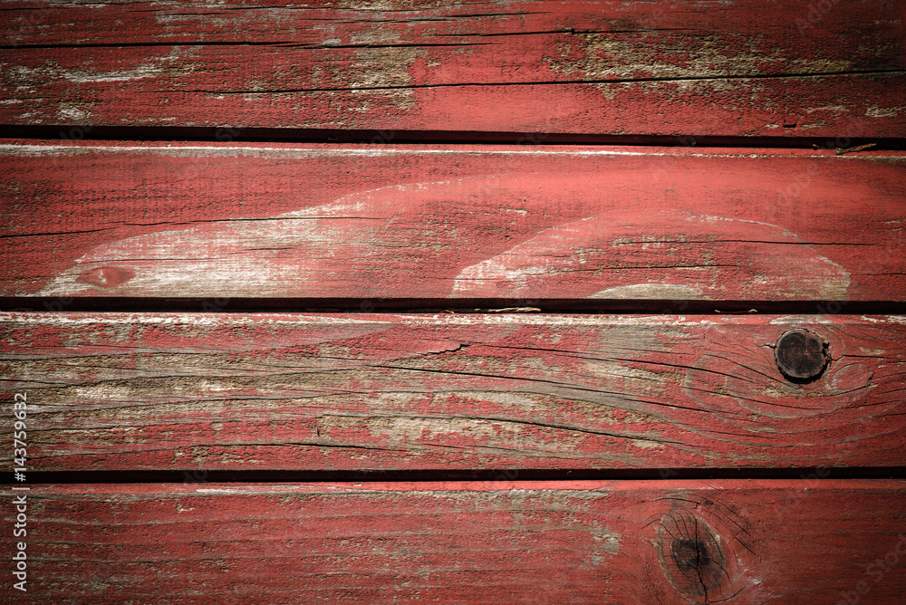 Old wooden wall painted in red color, detailed background photo texture. Wood plank fence close up.