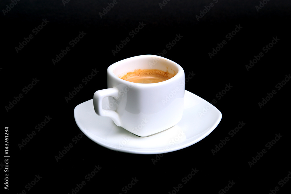Classic espresso coffee in white cup isolated on dark background. Top View. Classic espresso coffee in white cup isolated on dark background. Top View.