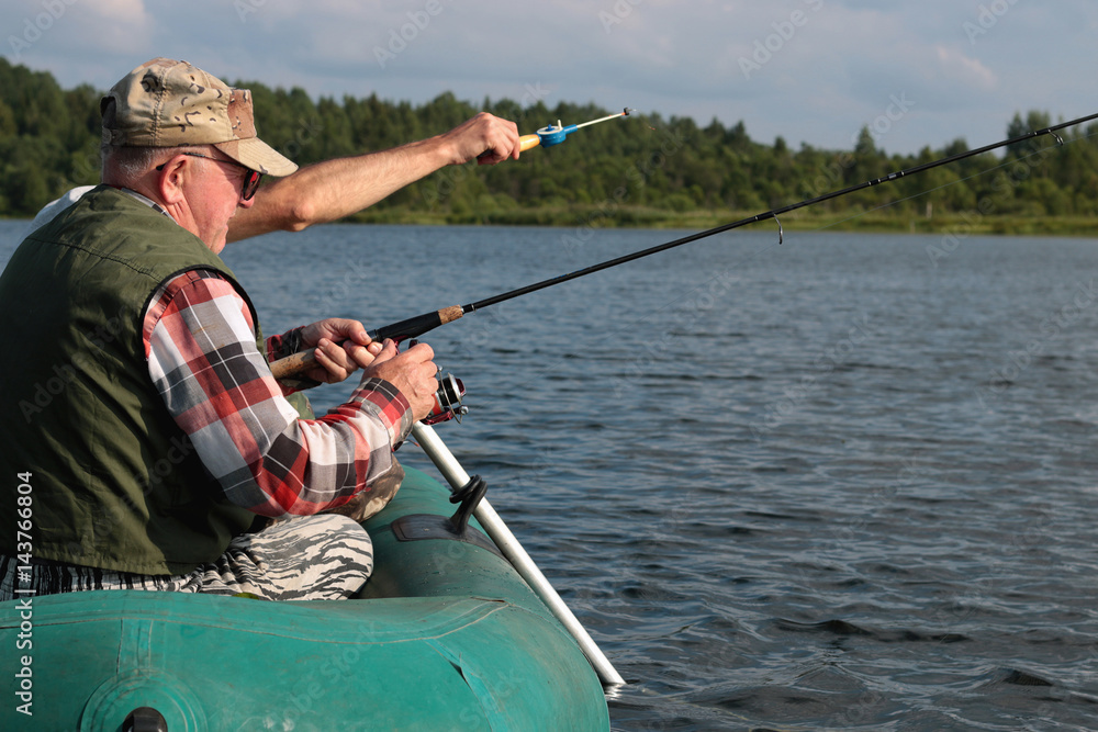 Spinning fisherman on a boat fishing Spinning fisherman on a boat fishing