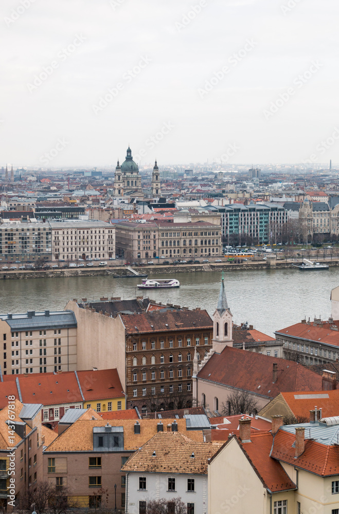 Scenic view of Pest side with St. Stephen's Basilica and Danube river in Budapest Hungary on a cloudy day