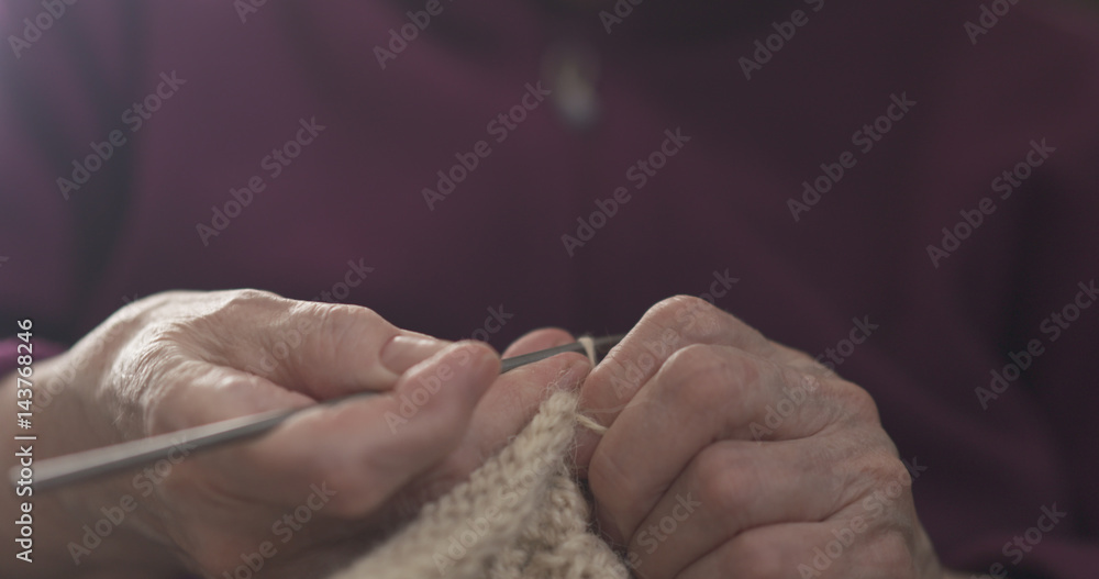 grandmother hands knitting sweater closeup, 4k photo