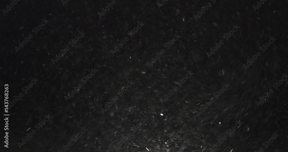 dust particles fast moving over black background from right, 4k photo