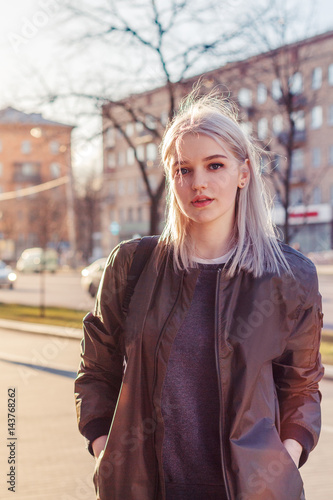 Beautiful attractive young girl in the evening in the city