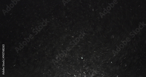 dust particles fast moving over black background from right, 4k photo