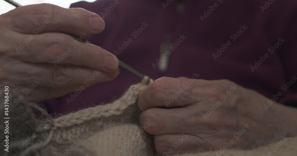 grandmother hands knitting sweater closeup, 4k photo