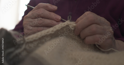 grandmother hands knitting sweater closeup  4k photo