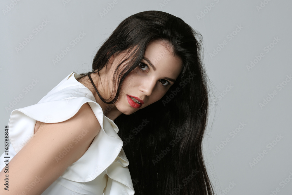 Portrait of a woman who is leaning forward and showing curvy hair Portrait of a woman who is leaning forward and showing curvy hair