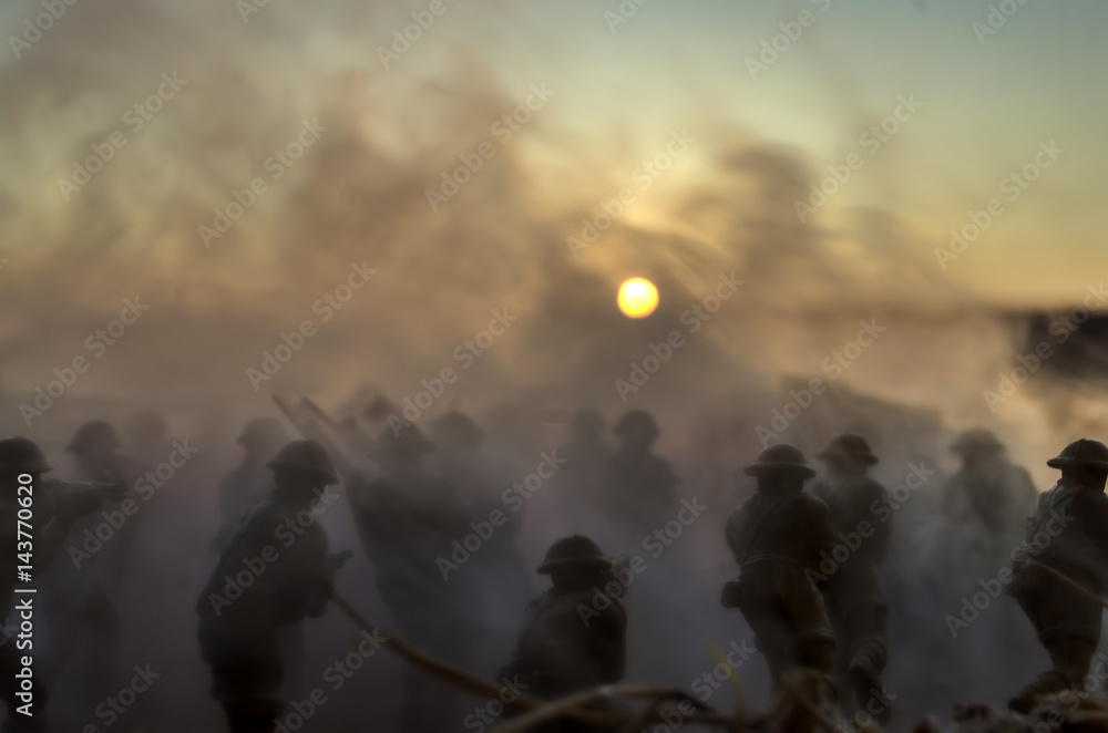 Fototapeta premium War Concept. Military silhouettes and tanks fighting scene on war fog sky background, World War Soldiers Silhouettes Below Cloudy Skyline At Dusk or Dawn. Attack scene