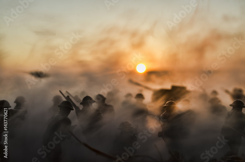 War Concept. Military silhouettes and tanks fighting scene on war fog sky background, World War Soldiers Silhouettes Below Cloudy Skyline At Dusk or Dawn. Attack scene photo