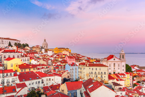 View of Alfama, the oldest district of the Old Town, Church of Saint Stephen and National Pantheon from belvedere Miradouro das Portas do Sol at scenic sunset, Lisbon, Portugal