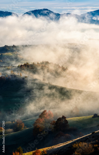 mountain rural area in foggy autumn morning