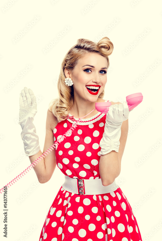 smiling woman with phone, dressed in pin-up style dress smiling woman with phone, dressed in pin-up style dress