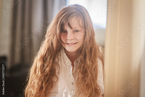 indoor portrait of young preteen girl at home photo