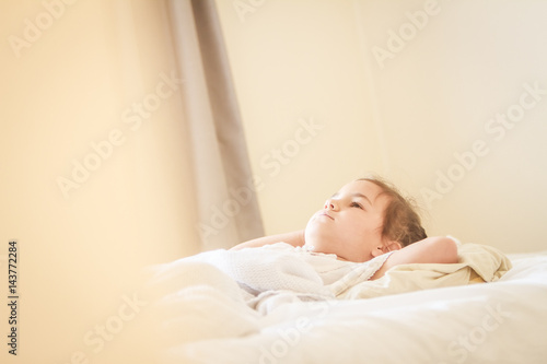 indoor portrait of young child girl wrapped in blanket