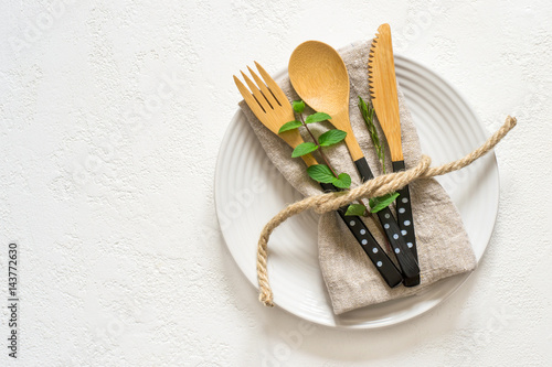 Natural table setting with bamboo knife fork and spoon, Top view with copy space
