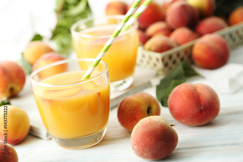 Glasses of peach juice on white wooden table Glasses of peach juice on white wooden table