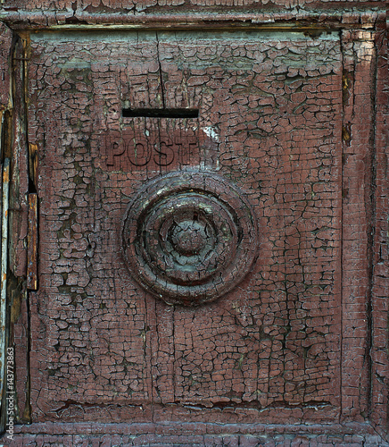 Fragment of an old door with cracked paint