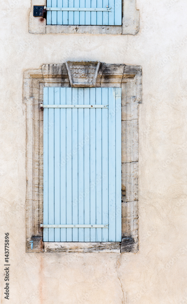 Old vintage rustic blue closed windows shutters French style architecture