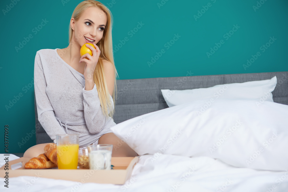 Young beautiful woman with cup of juice in bed Young beautiful woman with cup of juice in bed