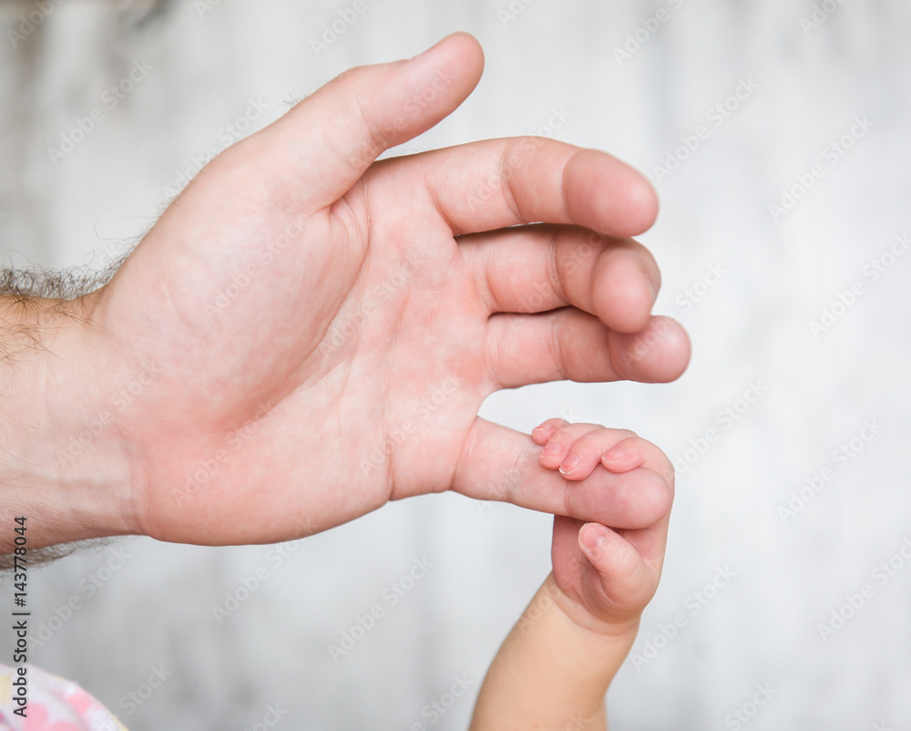 Newborn baby grasped the little finger of his father Newborn baby grasped the little finger of his father