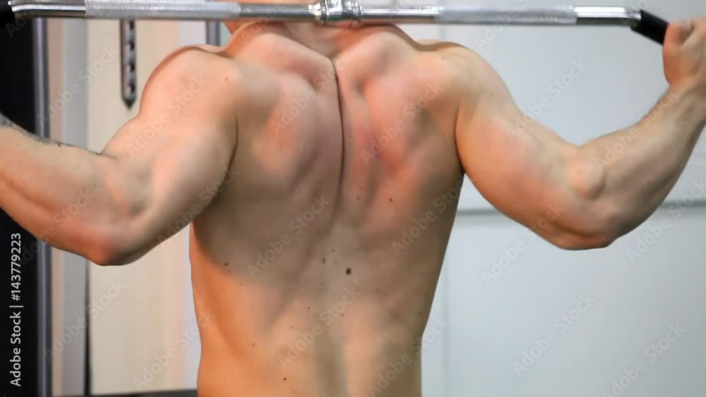 Young athletic man execute muscle exercises Young athletic man execute muscle exercises