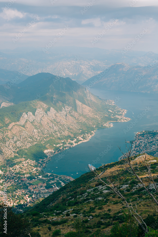 Bay of Kotor from the heights. View from Mount Lovcen to the bay. View down from the observation platform on the mountain Lovcen. Mountains and bay in Montenegro. The liner near the old town of Kotor.