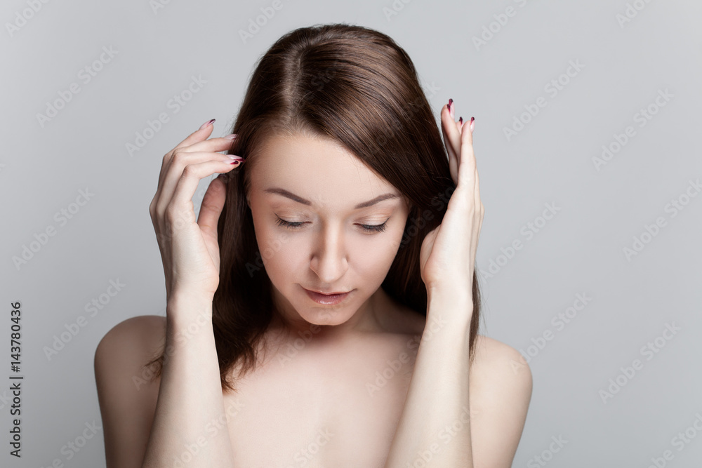 Isolated on gray background studio portrait of young brunette with manicure on nails Isolated on gray background studio portrait of young brunette with manicure on nails