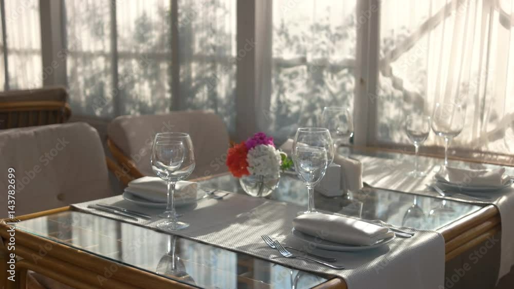 Dinner table and chairs. Tablecloth, silverware and plates. Dinner table and chairs. Tablecloth, silverware and plates.