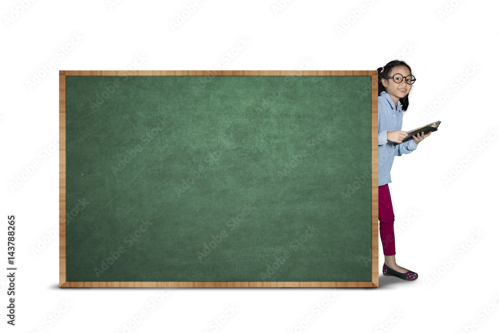 Smiling girl with blank chalkboard in studio Smiling girl with blank chalkboard in studio