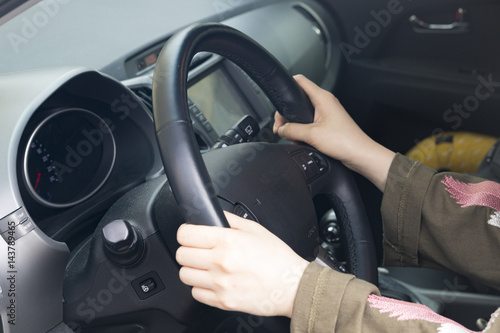 a woman is holding the steering wheel on the car