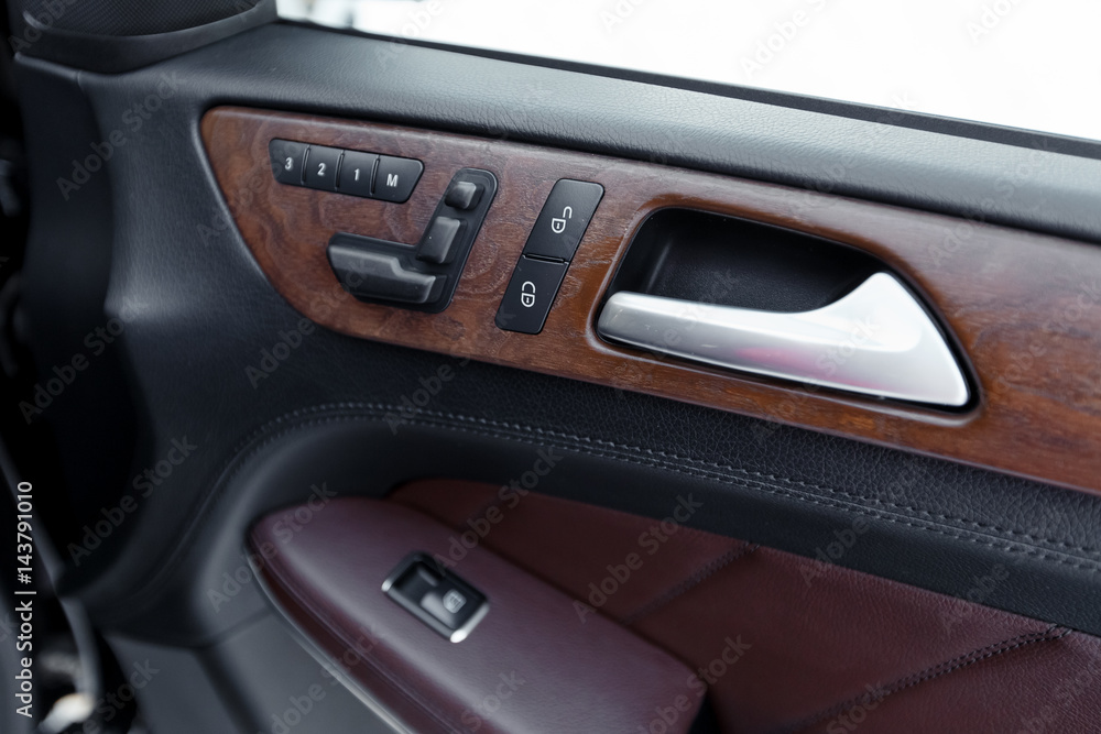 Door panel with power window controller. Detail of the car interior