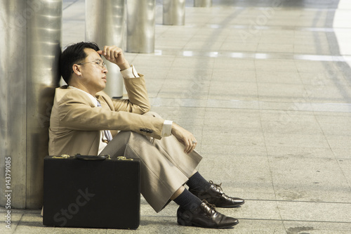 Asian Businessman failed to feeling hopeless, distraught, sad and discouraged in life. Business Stress Failed Unsuccessful Concept.