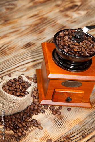 Wooden grinder with coffee on a  background