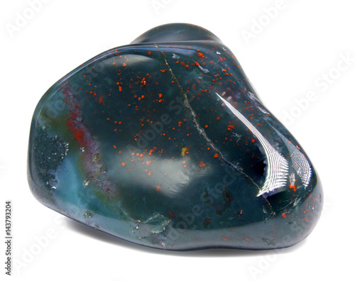 Heliotrope (bloodstone) gemstone isolated on white - macro 