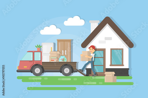 Moving to a new house. Man in uniform picks the furniture and puts it on the truck.