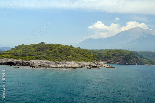 Resort Turkish. Blue water of the Mediterranean Sea. Beautiful amazing nature background. Huge rocks. Fresh freedom of the sea. Adventure day. A splendid paradise. The inspirational desert of water.