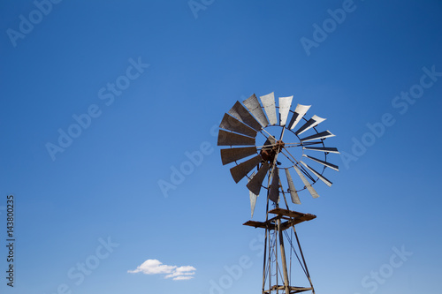 Close up wide angle image of a windmill / windpomp with static blades in the Tankwa Karoo in South Africa on a hot summersday