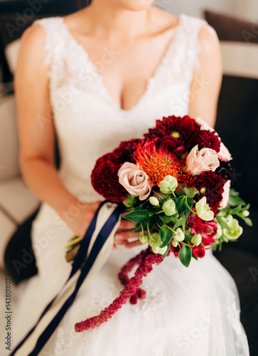 Wedding bridal bouquet of roses, celosia, Proteus in the hands of the bride. Wedding in Montenegro, Adriatic.