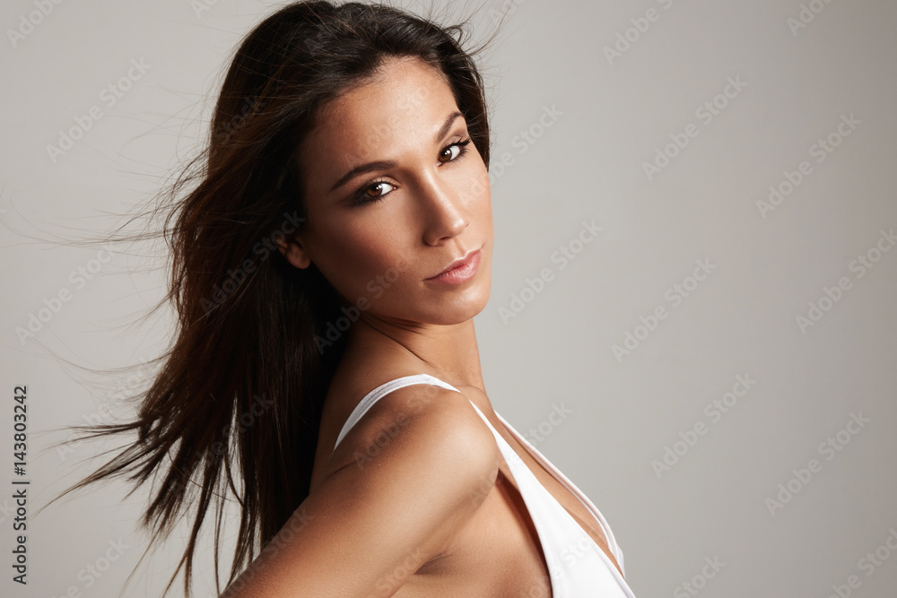 beauty spanish woman with long straight hair watching at camera. ideal skin  Stock-foto | Adobe Stock