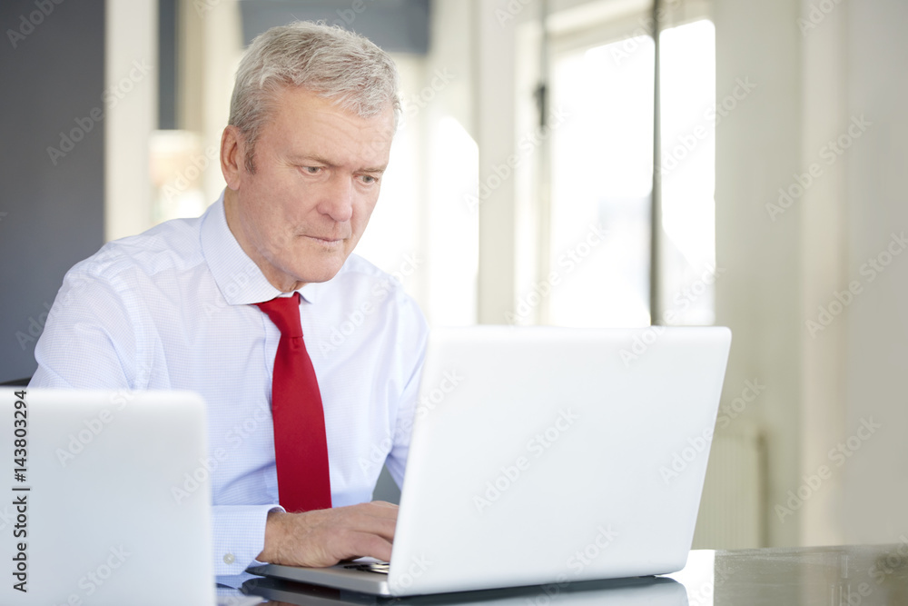 Senior manager portrait. Shot of an old overwhelmed business man working on laptop in the office. Senior manager portrait. Shot of an old overwhelmed business man working on laptop in the office.