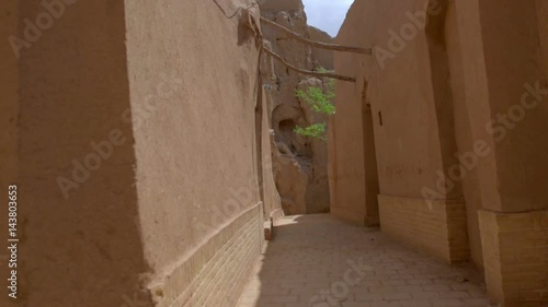 street in an old part of the Iranian city, house and wall are constructed of clay bricks