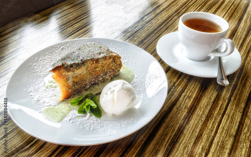 Carrot cake and a cup of tea on the table Carrot cake and a cup of tea on the table